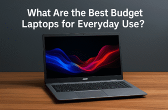 A high-resolution digital photograph features an open Acer Aspire 5 laptop with a vibrant abstract wallpaper on screen, placed on a wooden desk with a clean gray wall background